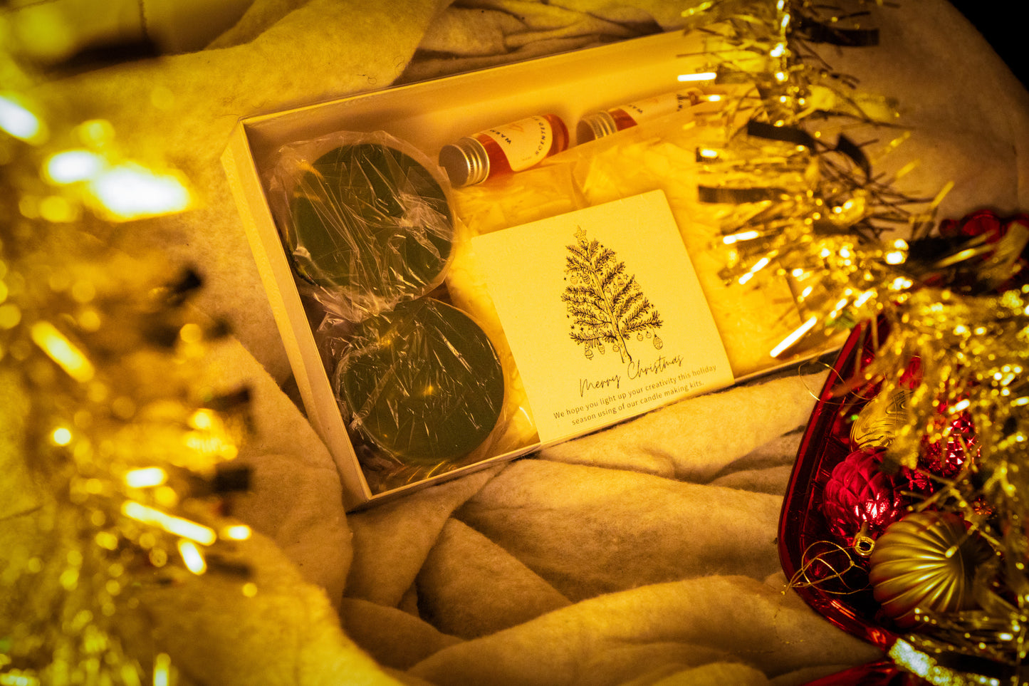 Box of candle making kit with a card on a festive background
